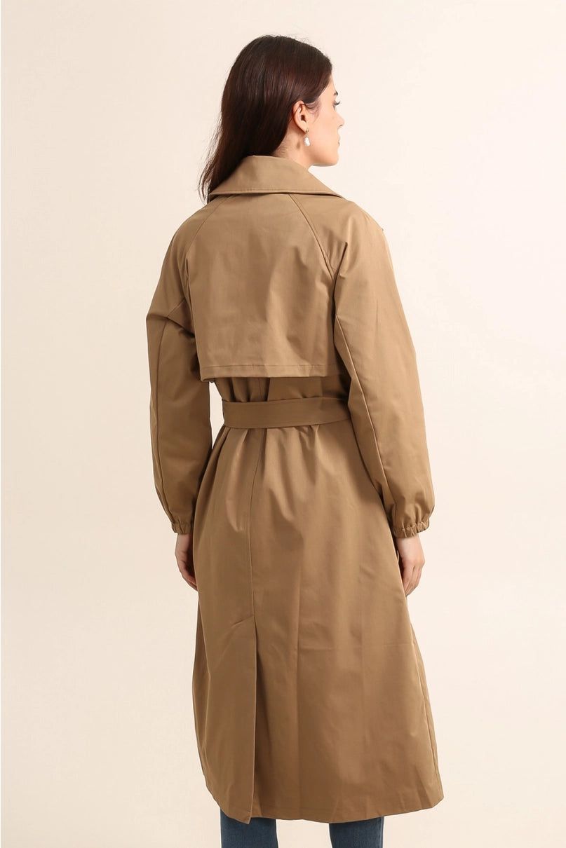 Woman wearing gale camel beige trench coat on a beige background - by penn and reid boutique leighton buzzard