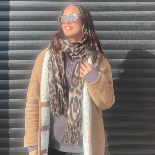 model wearing sunglasses with the sienna leopard print super soft scarf and the talula coord grey top 