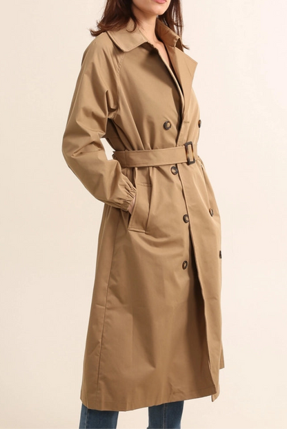 Woman wearing gale camel beige trench coat on a beige background - by penn and reid boutique leighton buzzard